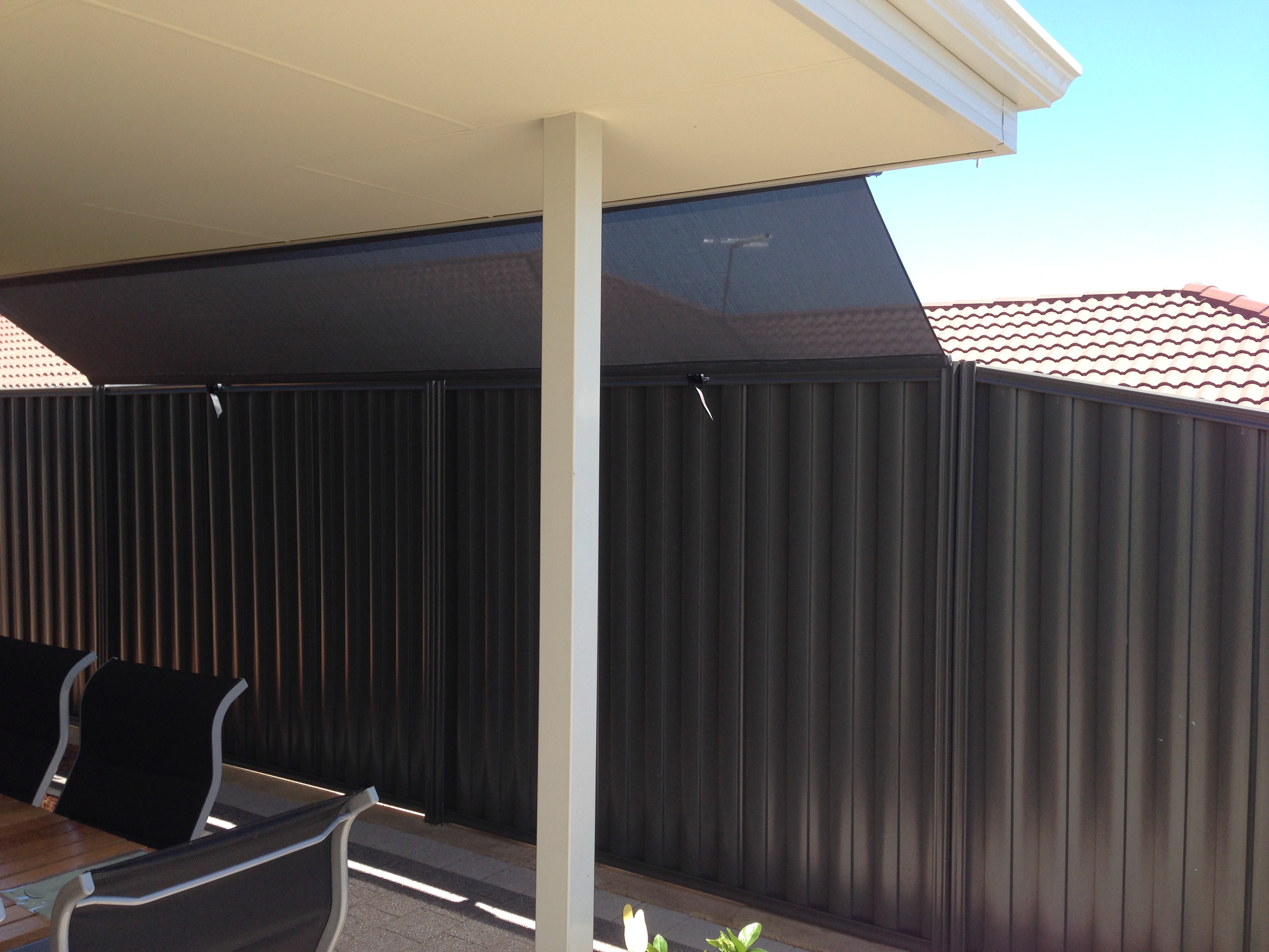 Roof to fence blinds enclosing a Sydney patio